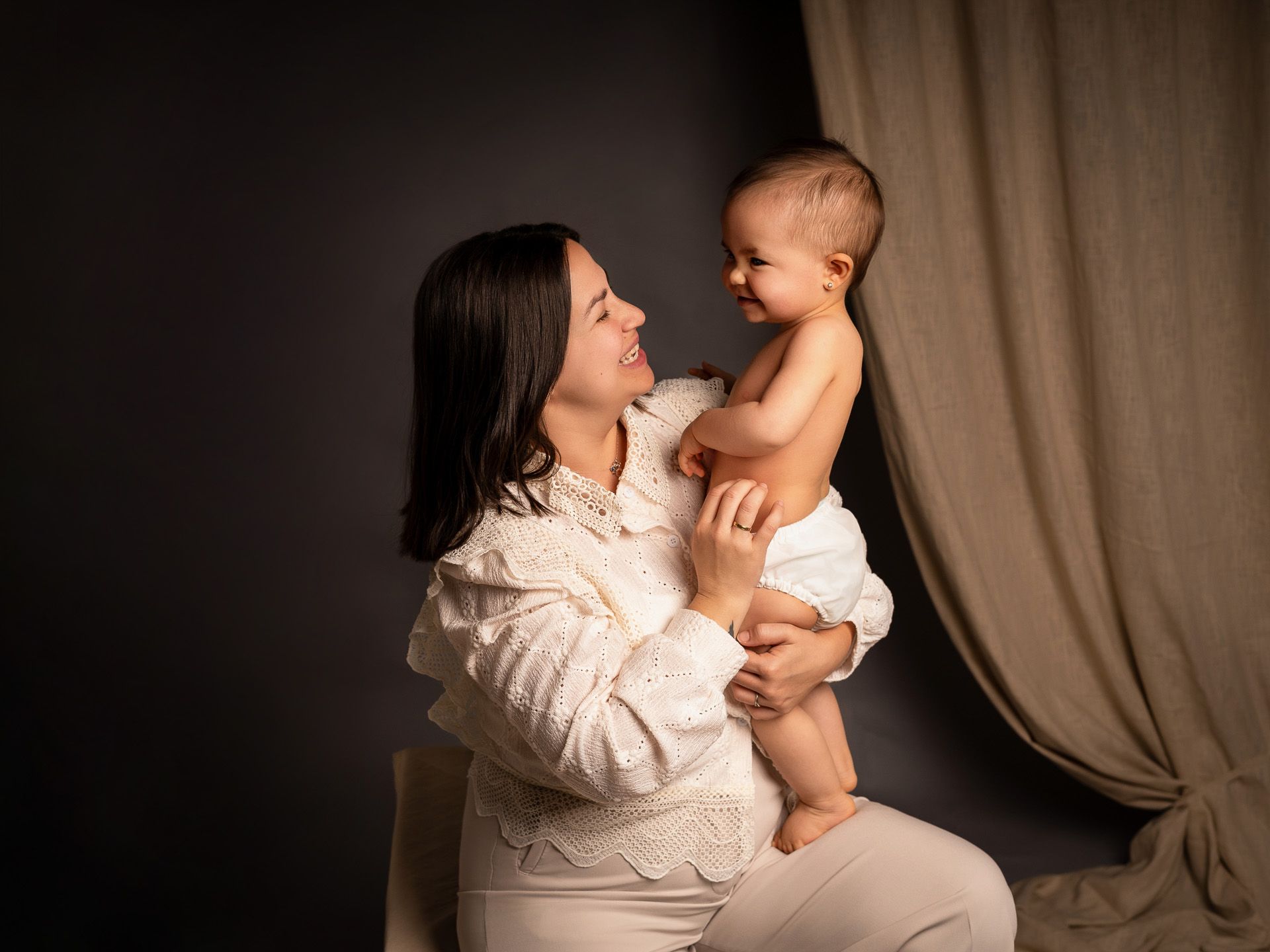 Mamá y bebé mirándose con alegría en un instante de conexión única por el Día de la Madre.