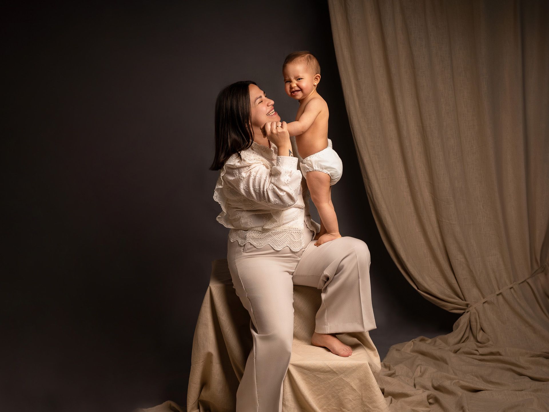 Madre abrazando a su bebé en un retrato íntimo de estudio